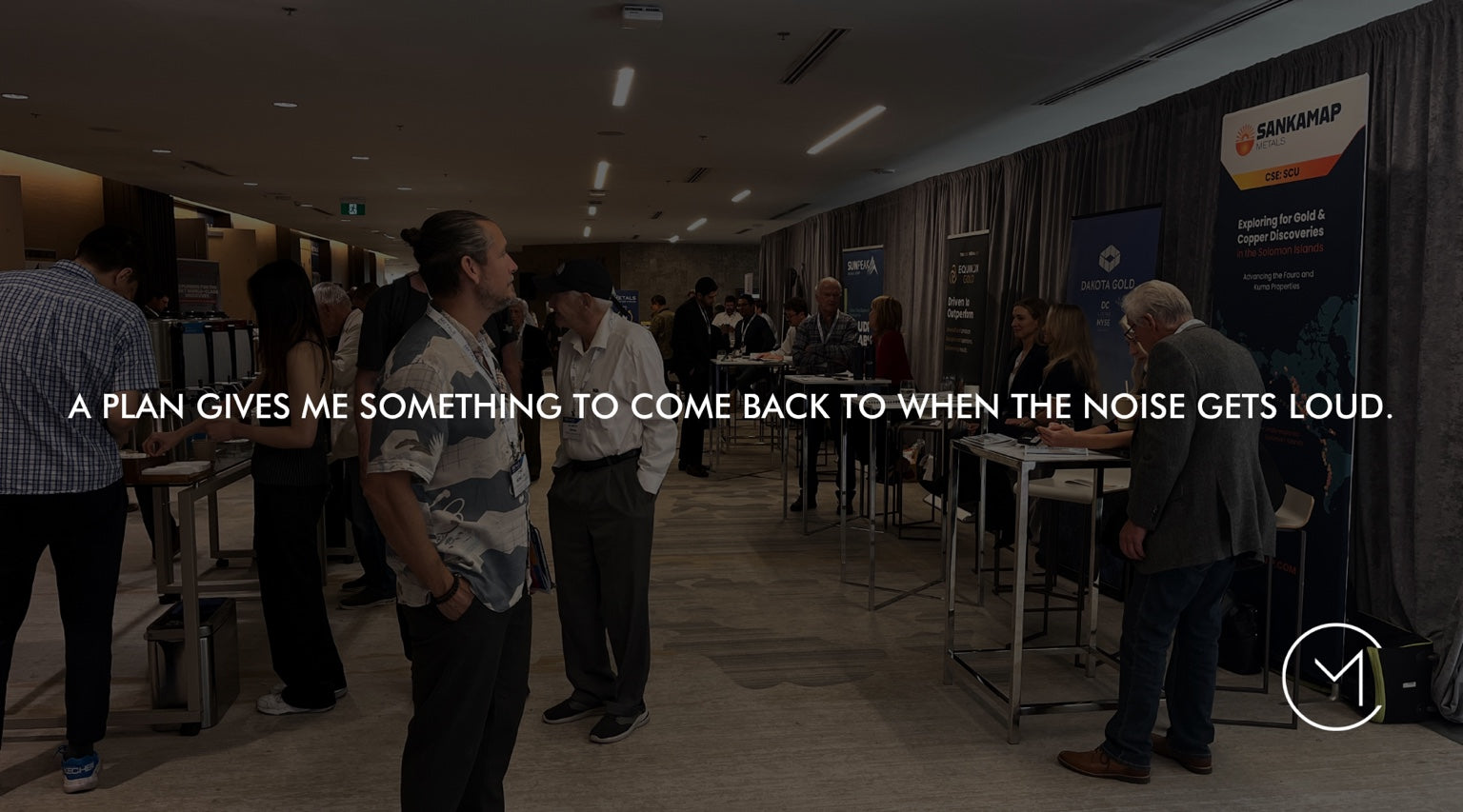 A man surveys a capital markets conference, illustrating the value of having a trading plan before entering a position.