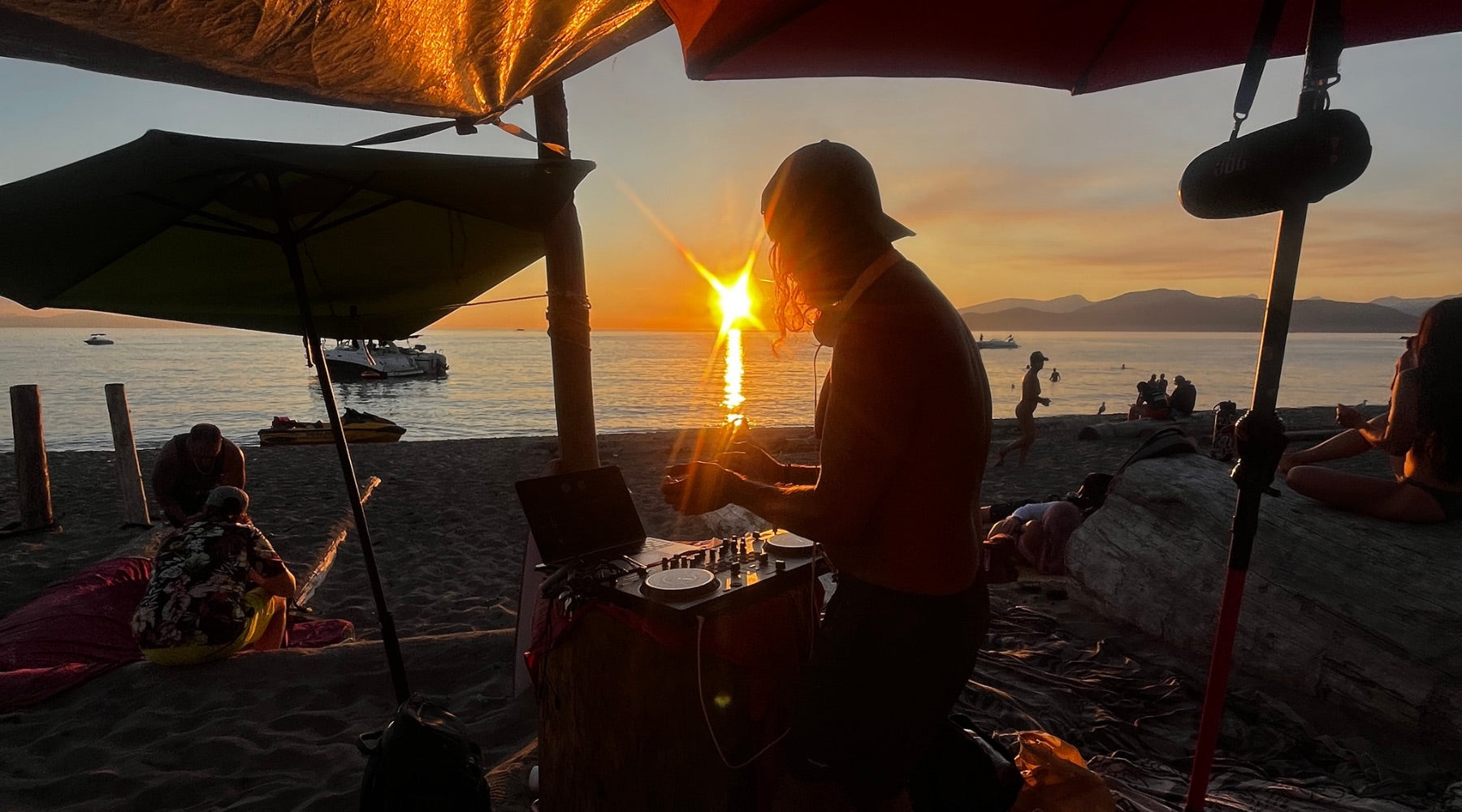Chad McMillan DJing on the beach at sunset