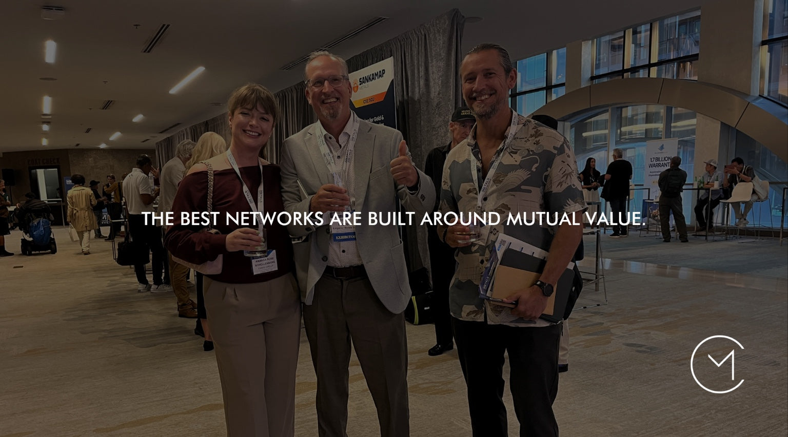 Three people connect at a business conference, illustrating strategic relationships, networking and creating mutual value.