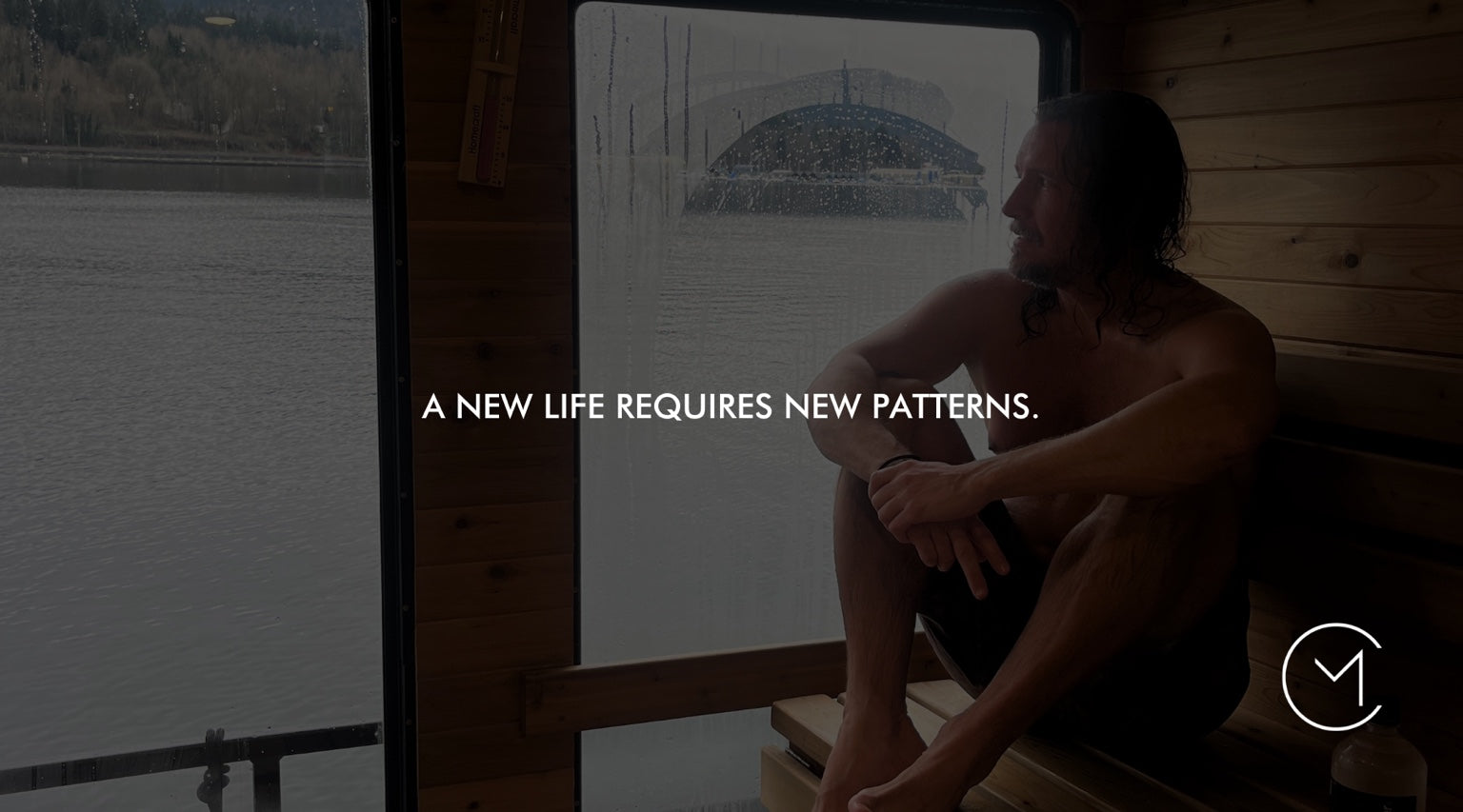 A man sits in a waterfront sauna, illustrating personal transformation and the new patterns required to change how you live.
