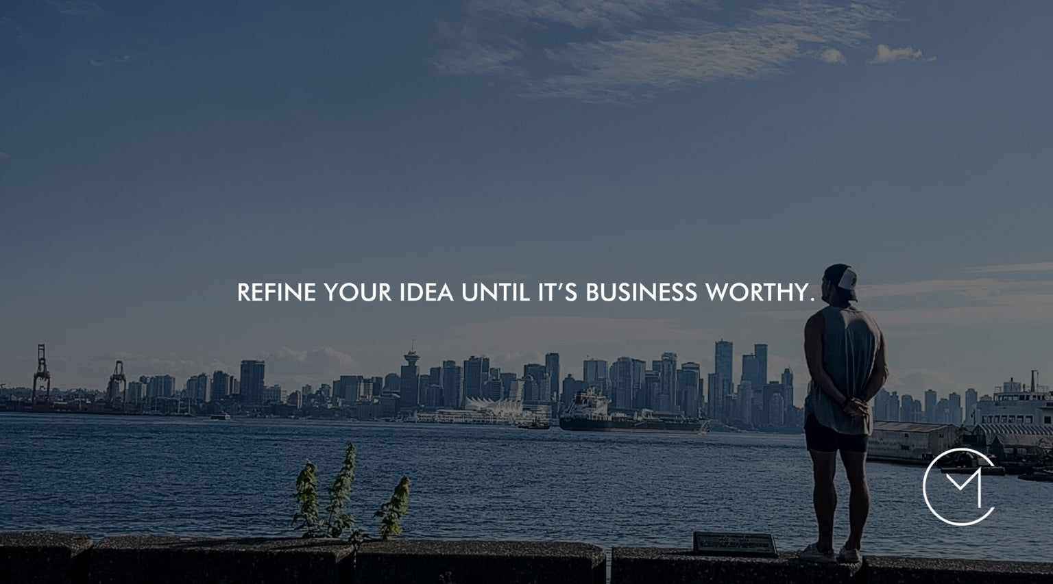 A man looks across the Vancouver skyline, illustrating the process of refining an idea until it is strong enough to become a business.