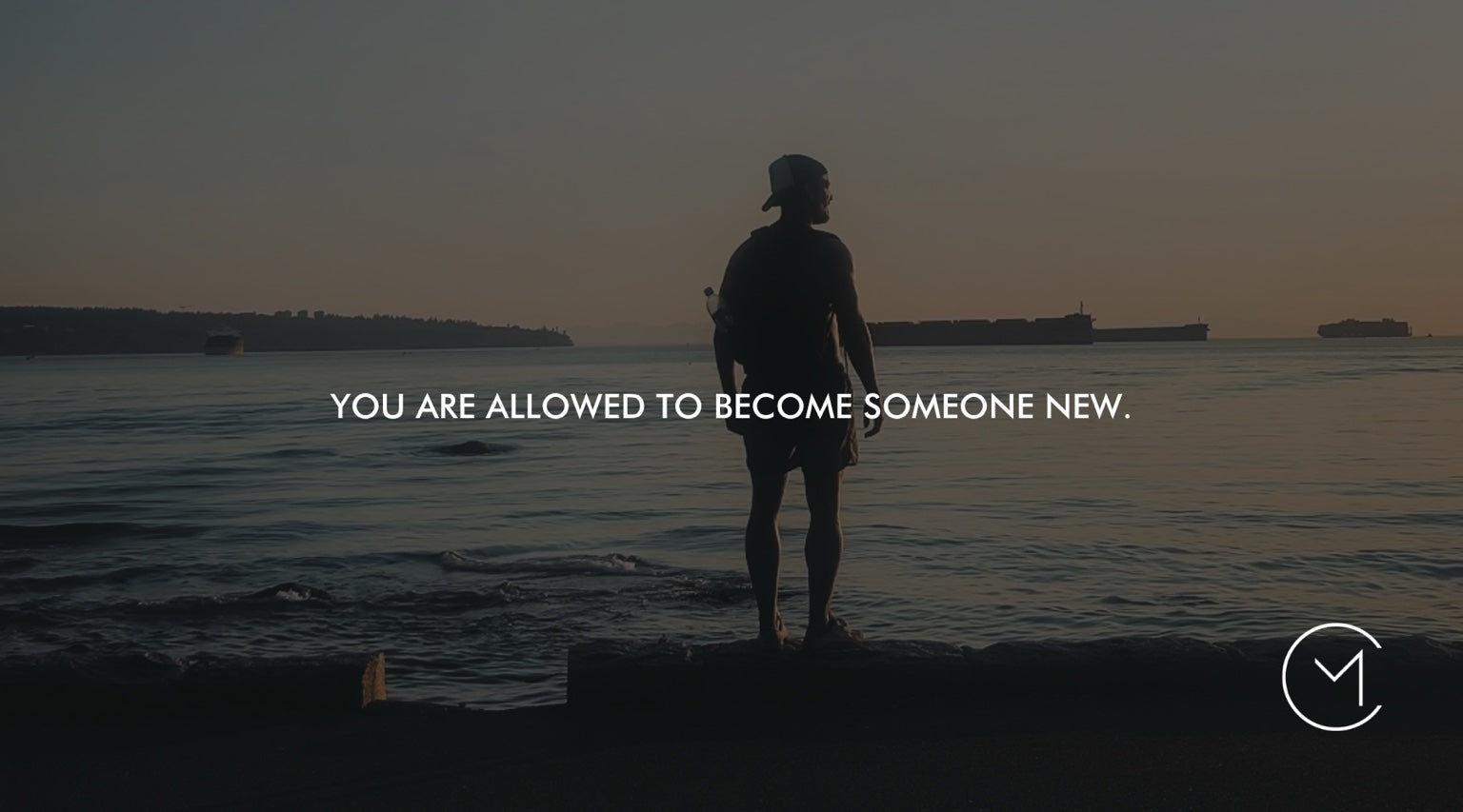 A person stands at the edge of the ocean at sunset, illustrating personal reinvention, identity and becoming someone new.