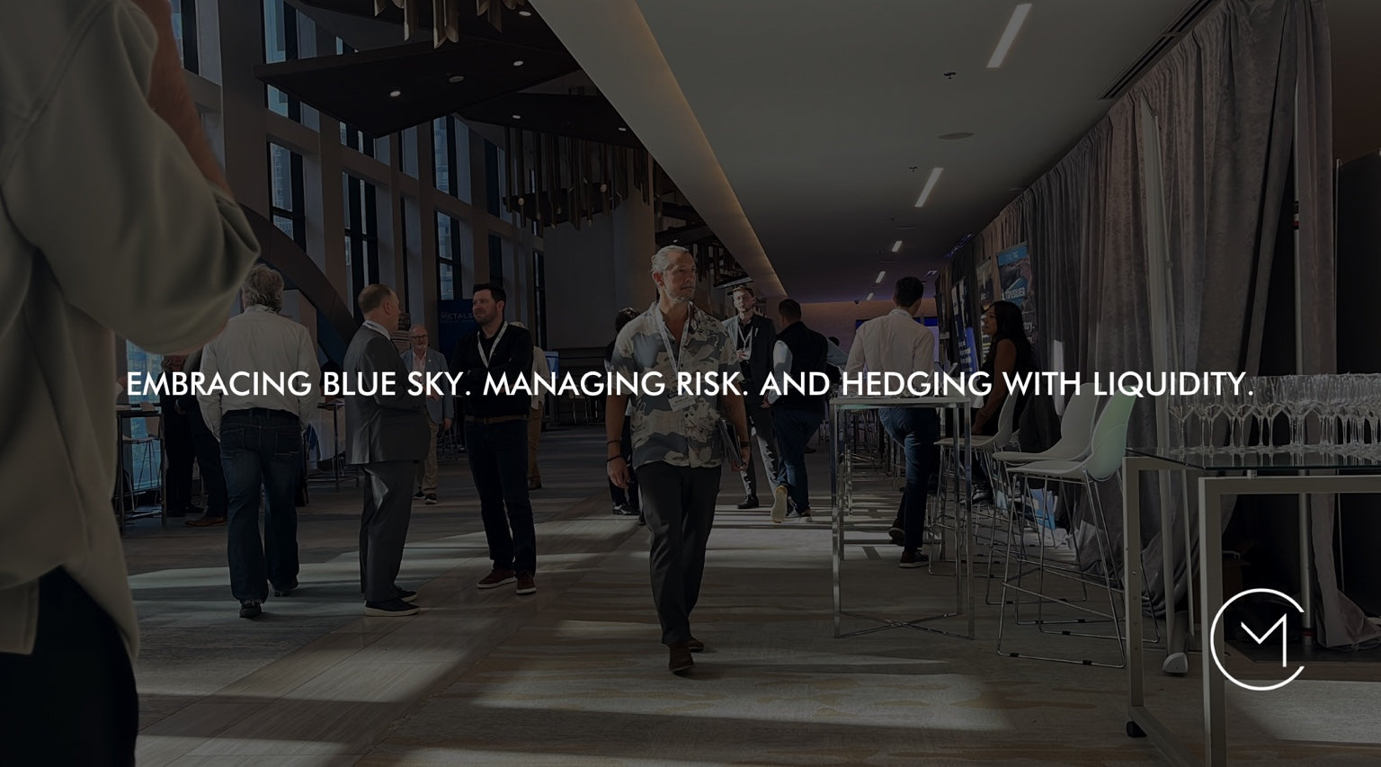 A man walks through a capital markets conference, illustrating the balance of opportunity, risk and liquidity in public versus private venture capital.