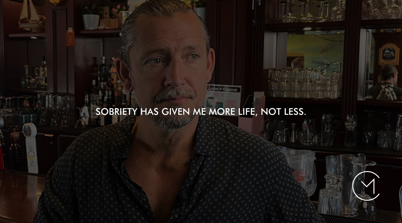 A man sits in a restaurant or lounge, illustrating a personal reflection on sobriety and the life it can make possible.