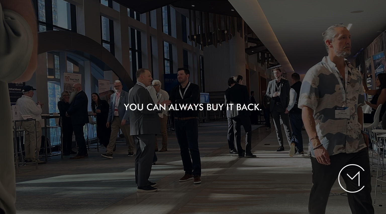 A man walks through a capital markets conference, illustrating the trading discipline of exiting a position and knowing you can always buy it back.